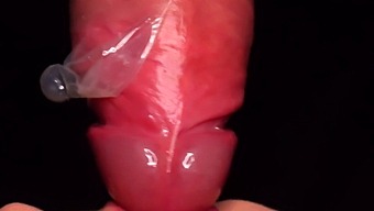 Intense Close-Up Of Woman Milking Cum From Condom Into Mouth